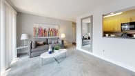Located at 146 Chestnut Crossing Dr in Newark, Delaware, this single-floor residence offers a well-designed layout with a consistent, modern aesthetic carried throughout each room. The living area is anchored by plush carpeting in a neutral gray tone, with a large sliding glass door that fills the space with natural light and connects to an outdoor area. A dining section sits adjacent, creating an open and functional flow. A large floor mirror and vibrant wall art add character to the living space.

The kitchen features light wood cabinetry paired with dark countertops and black appliances, including a refrigerator, electric range, microwave, and dishwasher. Wood-style flooring provides a warm contrast to the sleek cabinetry.

The bedrooms are carpeted and finished with soft gray walls, each offering a calm and restful atmosphere. Natural light enters through windows dressed with sheer curtains, and one bedroom includes direct access to a private bathroom. The bathrooms are clean and simply appointed, with light tile flooring, white fixtures, and brushed nickel hardware accents.

Overall, the space maintains a cohesive modern style, with a neutral color palette accented by pops of yellow and color through artwork and décor, creating a bright and inviting environment.