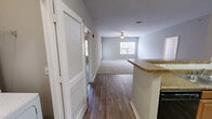 Located at 501 Tiger Way in Knoxville, Tennessee, this well-appointed single-story home offers three bedrooms and two full bathrooms across a comfortable and functional layout. The open-concept living area is bright and inviting, featuring plush carpet, a ceiling fan, and windows that bring in natural light with views of the surrounding greenery. Hardwood-style flooring runs through the kitchen and transitional spaces, creating a clean visual contrast.

The kitchen is well-equipped with warm wood cabinetry, granite-look countertops, a double sink, and black appliances. It opens conveniently toward the dedicated in-unit laundry area, which includes a full-size washer and dryer with overhead shelving. Louvered doors provide easy access while maintaining a tidy separation from the main living space.

The generously sized primary bedroom includes a ceiling fan and connects to a private bathroom with a granite-topped vanity and large mirror. Secondary bedrooms offer carpet flooring, sizable closets, and ample natural light through large windows. The second full bathroom features a tiled tub-shower combination, wood-toned cabinetry, and granite countertops. Two closets and a hallway round out the thoughtfully organized floor plan, making this home both practical and comfortable.