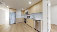 This penthouse apartment, located at 7050 Hawthorn Ave in Los Angeles, offers a contemporary living experience in a compact 840 square foot space. The unit boasts three bedrooms and three bathrooms, efficiently designed to maximize functionality. The open-concept layout seamlessly integrates the kitchen and living areas, creating a sense of spaciousness.

The kitchen is a highlight, featuring sleek light wood cabinetry, stainless steel appliances, and a modern backsplash. High-end appliances include a built-in microwave, electric range, and dishwasher, perfect for culinary enthusiasts.

Throughout the apartment, light wood flooring adds warmth and continuity. Large windows in the bedrooms and living areas allow for ample natural light, enhancing the airy feel of the space. The bathrooms are designed with a minimalist aesthetic, featuring glass shower enclosures and modern fixtures.

The primary bedroom, measuring 140 square feet, provides a cozy retreat. All rooms are finished with crisp white walls, offering a blank canvas for personalization. The apartment's design emphasizes clean lines and a neutral color palette, creating a contemporary and versatile living environment.

This penthouse unit combines modern amenities with efficient space utilization, ideal for those seeking a stylish urban lifestyle in the heart of Los Angeles.