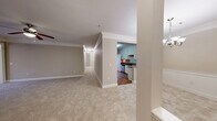 Located at 1050 Greystone Summit Dr in Cumming, GA, this well-appointed single-story home offers a thoughtfully designed layout across three bedrooms, two bathrooms, and a dedicated office space. The interior is finished with neutral warm-toned walls, plush carpet in the living and bedroom areas, and hardwood flooring in the kitchen and laundry room. Crown molding accents the living room and dining room, adding a classic touch throughout. The kitchen is outfitted with white shaker-style cabinetry, granite countertops, stainless steel appliances, and hardwood flooring, creating a clean and functional cooking space that opens to the main living area. The dining room features elegant beadboard wainscoting and a chandelier overhead. The spacious living room includes a ceiling fan and ample room for comfortable furnishings. The primary bedroom offers a generous footprint with a ceiling fan, natural light from windows, and direct access to a walk-in closet with wire shelving. Additional bedrooms also feature ceiling fans and natural light. Both bathrooms include tile flooring, vanities with granite countertops, and well-lit mirrors. A dedicated laundry room and utility space add practical convenience, while five closets throughout the home ensure abundant storage.