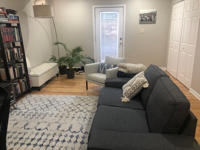 Living room rear apartment door - 5931 Walnut St Apartments