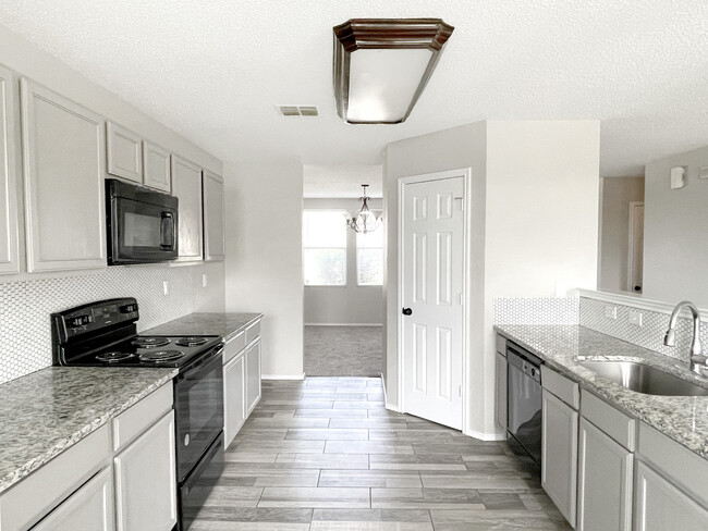 Eat-in looking through to formal dining. - 1419 Windy Meadows Dr