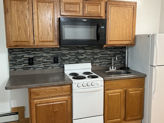 Kitchen with stove and microwave - 312 Green St