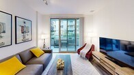 Located in the heart of Los Angeles at 1400 S Figueroa St, this modern single-floor residence offers a well-appointed, contemporary living experience. The open living area is bright and inviting, featuring sliding glass doors that lead to a private balcony with views of the surrounding urban landscape, seamlessly blending indoor and outdoor living. The space is accented with track lighting and stylish décor, including bold artwork that reflects the local LA character.

The kitchen is thoughtfully designed with dark wood cabinetry, frosted glass upper cabinets, a mosaic tile backsplash, white quartz countertops, and a full suite of stainless steel appliances including a gas range, microwave, refrigerator, and dishwasher. Wood-plank flooring runs throughout, adding warmth and continuity to the space.

The bedroom is a calm and comfortable retreat, featuring vertical blinds with ambient blue LED accent lighting, track ceiling lights, and ample room for relaxation. An adjoining bathroom is finished in clean white tile and includes a backlit vanity mirror, modern fixtures, and direct access to a walk-in closet with built-in shelving. Together, these elements create a cohesive, modern living environment in a prime Downtown Los Angeles location.