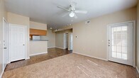 Located at 535 Gembler Road in San Antonio, TX, this single-story home offers a well-organized layout featuring three bedrooms, two bathrooms, a kitchen, dining room, laundry area, and multiple closets throughout. The open living and dining area is finished with durable wood-look flooring and fitted with a ceiling fan, creating a comfortable and functional gathering space. The kitchen is designed in a galley style, featuring warm honey-toned cabinetry, dark laminate countertops, a double sink, and white appliances including a range, microwave, and refrigerator. A peninsula with pendant lighting adds a convenient prep and serving area that opens toward the dining space. The bedrooms are carpeted for comfort, each equipped with a ceiling fan and window with blinds that allow natural light to filter in. The primary bedroom offers a generous footprint with direct access to a closet. The bathrooms are finished with wood-look tile flooring and include a tub-shower combination with white tile surround and oak cabinetry for storage. Neutral beige tones are carried consistently throughout the home, lending a clean and cohesive aesthetic. Two hallways connect the living areas to the private quarters, and the laundry room adds everyday convenience. The layout is practical and efficient, making effective use of the available space.