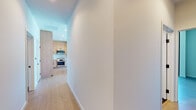 Located in the heart of Hollywood at 1755 Argyle Ave, this thoughtfully designed single-floor residence combines contemporary architecture with high-end finishes throughout. Wide-plank hardwood flooring flows seamlessly across the living areas, complemented by clean white walls and recessed lighting that create a bright, airy atmosphere.

The kitchen is a standout feature, showcasing flat-front light oak cabinetry extending to the ceiling for ample storage, a light-toned tile backsplash, stainless steel appliances including a gas range, built-in microwave, and wall oven, as well as a generous island with a crisp white countertop. Floor-to-ceiling windows frame sweeping views of the Hollywood Hills, flooding the space with natural light.

The bedrooms continue the modern aesthetic with expansive wall-to-wall windows offering dramatic hill and cityscape views, and warm hardwood flooring underfoot. The unit features two well-appointed bathrooms: one with a frameless glass shower enclosure and mosaic tile walls, and another with a combined soaking tub and shower behind frameless glass, both with light oak vanities and white quartz countertops. The overall ambiance is sleek, sophisticated, and bathed in natural light with memorable Los Angeles views.