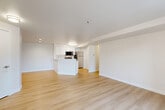 Located at 320 Cascade Pl in Burlington, WA, this 2-bedroom, 3-bathroom residence offers a well-designed single-level layout that maximizes every square foot. The open-concept living and kitchen area serves as the heart of the home, featuring light hardwood-style flooring, crisp white walls, and an abundance of natural light. The kitchen is outfitted with white shaker cabinetry, light quartz countertops, a stainless steel sink, and a full suite of stainless steel appliances including a refrigerator, electric range, microwave, and dishwasher. The living room is highlighted by a corner fireplace with a sleek tile surround and sliding glass doors that open to a private balcony with outdoor views. Both bedrooms are carpeted for comfort, with the primary bedroom offering an en-suite bathroom and dedicated closet space. Three full bathrooms serve the home, each finished in a clean, neutral palette with tub/shower combinations and brushed nickel fixtures. A hallway connects the bedroom wing to the main living area, and two closets provide ample storage. The overall ambiance is bright, clean, and move-in ready, with a cohesive modern aesthetic throughout.