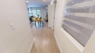 Located at Skyway in Calgary's southwest, this 2-bedroom, 2-bathroom unit offers a thoughtfully planned open-concept layout finished with light hardwood-style flooring, recessed lighting, and a clean, contemporary palette throughout. The combined kitchen and living area forms the heart of the home, where a fully equipped kitchen showcases two-tone cabinetry — warm wood lowers paired with crisp white uppers — complemented by open shelving, a subway tile backsplash, stainless steel appliances, and a white quartz countertop. A dining area flows naturally from the kitchen toward the bright living room, which features a wall-mounted mini-split system for year-round comfort and access to natural light through a large window. The primary bedroom offers a serene retreat with its own walk-in closet, while the second bedroom provides a versatile space suitable for various configurations. Both bathrooms are finished with modern wood-tone vanities and light countertops; one features a glass-enclosed walk-in shower with marble-style tile. The consistent use of light tones, clean lines, and quality finishes gives the entire unit a cohesive and contemporary feel.