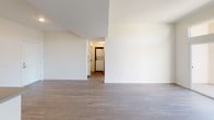 Located at 13650 Leadwell St in the Van Nuys neighborhood of Los Angeles, this single-story unit offers a clean, modern aesthetic throughout. Consistent hardwood-style flooring runs across all rooms, lending a cohesive and contemporary feel to the interior.

The open living area provides a generous sense of space, with crisp white walls and a layout that connects seamlessly to the kitchen. The kitchen is well-appointed with stainless steel appliances, including a refrigerator, range, and microwave, complemented by white cabinetry and dark countertops. Recessed lighting adds a polished touch to the space.

The bedrooms are bright and airy, with large windows that invite natural light and offer views of surrounding greenery. Each bedroom includes a mirrored sliding closet, maximizing storage and enhancing the sense of openness.

The bathroom features a clean, functional design with white cabinetry, a dual-sink vanity topped with a dark countertop, a large mirror, and a shower-tub combination. A dedicated in-unit laundry area with a stacked washer and dryer adds everyday convenience. Overall, the unit presents a modern, well-maintained living environment.