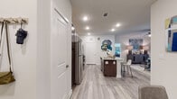 This single-floor residence offers a thoughtfully designed open-concept layout that seamlessly connects the kitchen, dining, and living areas. The kitchen is a standout feature, showcasing rich dark-toned cabinetry, granite countertops, a rounded island with bar seating, and a full suite of stainless steel appliances including a refrigerator, range, and built-in microwave. Light wood-style flooring runs throughout the main living spaces, creating a warm and cohesive feel.

The living room is bright and welcoming, with large windows dressed in sheer curtains that allow natural light to filter in, complemented by a ceiling fan overhead. The bedrooms continue the airy aesthetic, each featuring generous windows with blinds and drapes, ceiling fans, and light flooring.

Both bathrooms are finished with marble-style tile flooring and surround, dark cabinetry with granite countertops, and tub-shower combinations with curved curtain rods. Upper storage cabinets provide practical utility while maintaining a clean, polished look.

Throughout the residence, neutral wall tones and recessed lighting create a calm, modern ambiance. The overall design balances contemporary finishes with functional living spaces, making it a comfortable and stylish home.