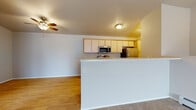 Located at Cityview Blvd in Horicon, Wisconsin, this single-story unit offers a practical and well-organized layout designed for comfortable everyday living. The open-concept kitchen is a central feature, equipped with light wood cabinetry, a stainless steel refrigerator, microwave, and a range. A peninsula with a light-toned countertop separates the kitchen from the adjoining living area, which features warm hardwood-style flooring and a ceiling fan overhead. The living space transitions into carpeted areas, providing a comfortable and cohesive flow throughout.

The bedrooms are carpeted and generously sized, each featuring wall-mounted heating units and individual climate control. One bedroom includes sliding glass doors that open to a private patio, bringing in natural light and outdoor views. The unit includes two bathrooms: one with a tub-shower combination and a vanity with light wood cabinetry, and a second with a walk-in shower stall and matching finishes. Hardwood-style flooring carries through both bathrooms.

A dedicated in-unit laundry area houses a full-sized washer and dryer, adding everyday convenience. Throughout the unit, neutral tones and clean finishes create a bright, move-in-ready atmosphere.