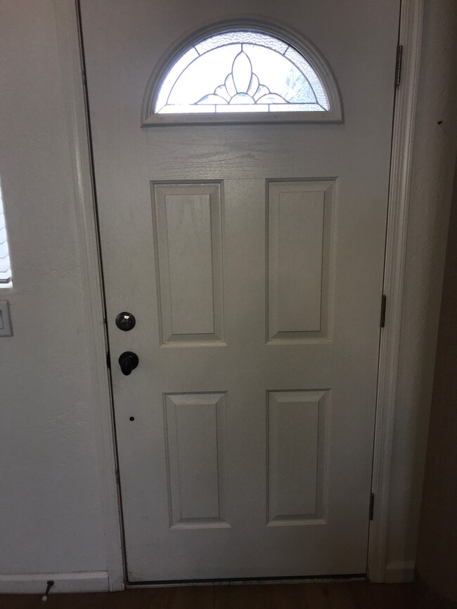 Front door with semi-circular decorative window for more natural light in the great room. - 175 Divot Dr