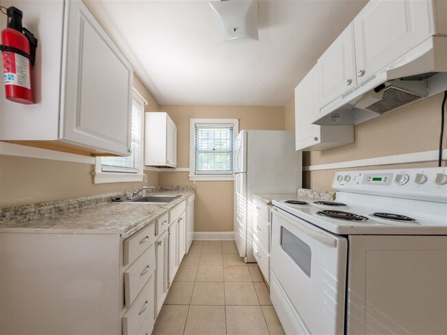 Naturally lit kitchen with refrigerator, stove, and dishwasher - 1744 N Parkway