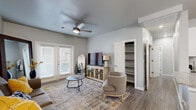 Located in El Paso, TX, this single-story 2-bedroom, 3-bathroom home offers a thoughtfully designed layout with modern finishes throughout. The living room serves as the heart of the home, featuring wood-look flooring, a ceiling fan, and a set of French doors that invite natural light and provide outdoor access. An open built-in shelving unit adds practical storage directly off the living area.

The galley-style kitchen is well-equipped with white shaker cabinets, granite countertops, stainless steel appliances, and a full suite including a refrigerator, range, microwave, and dishwasher. Light tile flooring and ample cabinetry above and below the counters make this an efficient and attractive workspace.

The primary bedroom is a comfortable retreat with multiple windows, wood-look flooring, and a ceiling fan. The additional bedroom is similarly bright, offering generous natural light and a ceiling fan. Both rooms are supported by well-appointed bathrooms, including one featuring a dual-sink vanity with granite countertops and a tub-shower combination with floor-to-ceiling tile surround.

A dedicated laundry room with side-by-side washer and dryer hookups adds everyday convenience. Two closets and a hallway complete the functional floor plan, making this home ideal for those seeking comfort and practicality in a clean, contemporary setting.