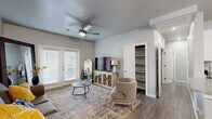 Located in El Paso, TX, this single-story 2-bedroom, 3-bathroom home offers a thoughtfully designed layout with modern finishes throughout. The living room serves as the heart of the home, featuring wood-look flooring, a ceiling fan, and a set of French doors that invite natural light and provide outdoor access. An open built-in shelving unit adds practical storage directly off the living area.

The galley-style kitchen is well-equipped with white shaker cabinets, granite countertops, stainless steel appliances, and a full suite including a refrigerator, range, microwave, and dishwasher. Light tile flooring and ample cabinetry above and below the counters make this an efficient and attractive workspace.

The primary bedroom is a comfortable retreat with multiple windows, wood-look flooring, and a ceiling fan. The additional bedroom is similarly bright, offering generous natural light and a ceiling fan. Both rooms are supported by well-appointed bathrooms, including one featuring a dual-sink vanity with granite countertops and a tub-shower combination with floor-to-ceiling tile surround.

A dedicated laundry room with side-by-side washer and dryer hookups adds everyday convenience. Two closets and a hallway complete the functional floor plan, making this home ideal for those seeking comfort and practicality in a clean, contemporary setting.