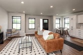 Located at 3245 Latimer Lane in Ames, Iowa, this two-story home offers a thoughtfully designed layout spread across two floors. The main level is the larger of the two, providing generous living space that includes an open-concept kitchen and living room. The kitchen features crisp white shaker-style cabinetry with black hardware, light countertops, a double sink, and white appliances including a range, dishwasher, and refrigerator. Warm hardwood-style flooring flows throughout the main level, complementing the bright, neutral color palette. The living room is a welcoming, well-lit space with recessed lighting and room for multiple seating areas. The upper floor houses the three bedrooms, each finished with plush carpeting, ceiling fans, and windows that invite natural light. The primary bedroom is a comfortable retreat with multiple windows framed in sleek black trim. Both bathrooms are finished with white cabinetry, large vanity mirrors, light countertops, and classic mosaic tile flooring, with tub and shower combinations. Two hallways and two closets add to the home's practical storage and circulation. The staircase connects the two floors seamlessly, completing this clean, modern, and functional home.