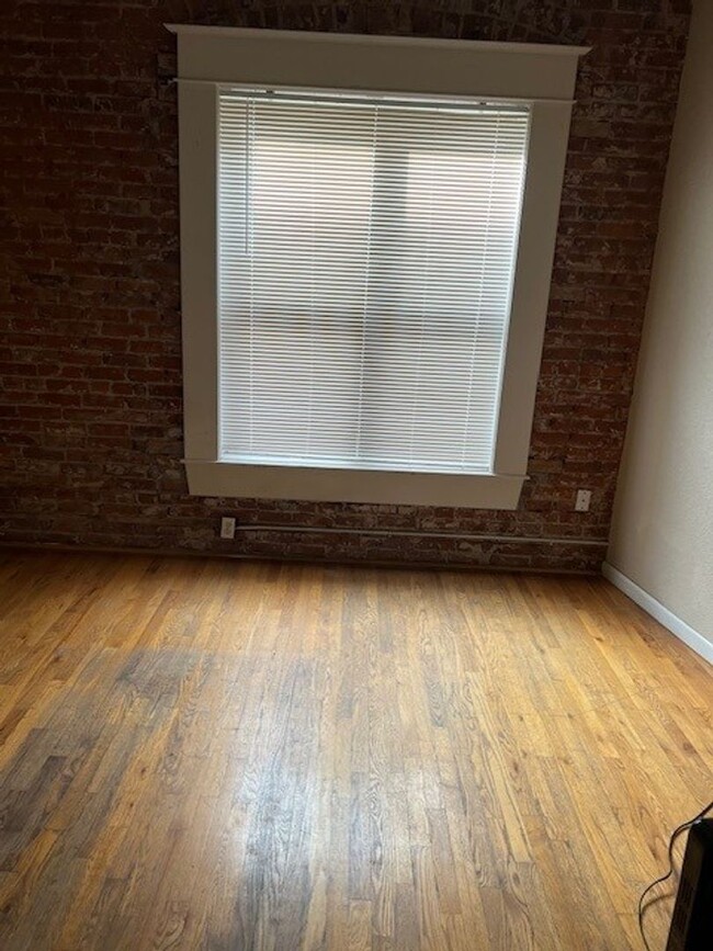 Foto del edificio - Large windows and exposed brick wall