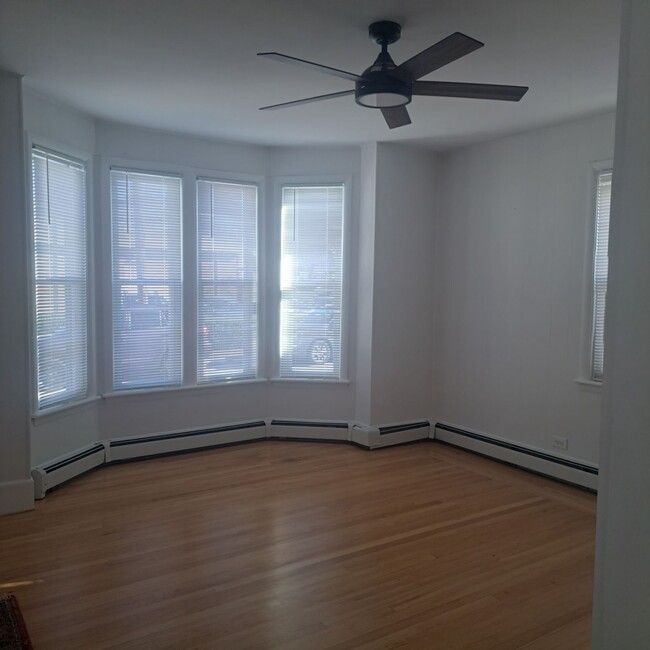 Freshly Sanded floors and painted living room with modern fan fixture - 12 Tiffany St