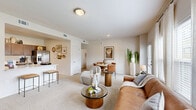 Located at 8800 N Ames Dr in Kansas City, MO, this single-floor residence offers three bedrooms and three bathrooms within a thoughtfully designed layout. The living room serves as a welcoming centerpiece, featuring plush carpeting, large windows that flood the space with natural light, and a sleek linear fireplace set against a clean white wall — ideal for relaxed gatherings. The kitchen is well-appointed with rich dark-stained cabinetry, white countertops, a classic subway tile backsplash, and a full suite of stainless steel appliances, including a range and refrigerator, all complemented by wood-look tile flooring. The primary bedroom is a comfortable retreat with ceiling fan, corner windows, and soft carpeting, while additional bedrooms offer similar comfort with ample natural light and ceiling fans. Each bathroom is finished with clean white tile and tub-shower combinations. Two closets provide practical storage throughout. The neutral color palette and consistent finishes lend a cohesive, modern feel to the entire residence, making it a functional and inviting home.