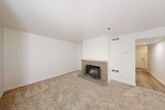 Located at 725 College Ave in Santa Rosa, California, this two-story, 3-bedroom, 3-bathroom home offers a functional and comfortable layout spread across two well-proportioned floors. The main level features a welcoming living room anchored by a classic brick fireplace, providing a warm focal point beneath clean white walls and plush carpeting. Light-toned wood flooring flows through the entryway and kitchen areas, lending a cohesive feel to the common spaces. The kitchen is equipped with dark wood cabinetry, granite-style countertops, stainless steel appliances including a range and dishwasher, and a double-basin sink — a practical and well-appointed space for everyday cooking. An adjacent dining room completes the lower-level living area. A sliding glass door opens directly to a private, fenced patio surrounded by mature trees, offering an intimate outdoor retreat. The upper floor houses the bedrooms, each carpeted and filled with natural light through generously sized windows framing greenery outside. The primary bedroom offers a comfortable footprint with ample closet access. Three bathrooms feature tub/shower combos, vanities with white cabinetry, and wood-look flooring. A dedicated laundry area and utility room add everyday convenience to this well-rounded Santa Rosa home.