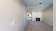Located at 275 East Minnesota Avenue in Turlock, California, this single-story, 2-bedroom, 2-bathroom home offers a practical and comfortable layout. The living room serves as the heart of the home, highlighted by a tile-surround fireplace with glass doors and plush wall-to-wall carpeting, creating a warm and inviting atmosphere. The kitchen features warm wood cabinetry, laminate flooring, a double-basin sink, and includes a range, dishwasher, and refrigerator, all arranged in an efficient U-shaped layout with a window that brings in natural light.

The primary bedroom is a generously sized retreat with vaulted ceilings, a ceiling fan, dual windows overlooking lush greenery, and a sliding double-door closet. An en-suite bathroom offers a single-sink vanity with wood cabinetry. The second bedroom also features carpeting, a ceiling fan, and a window with outdoor views. Both bathrooms are well-appointed with wood-toned vanities and full tub-shower combinations with laminate flooring. A hallway and dedicated closet complete the thoughtful floor plan. Neutral tones throughout create a clean, move-in-ready canvas.