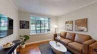 Located at 804 W Morgan St in Raleigh, NC, this 2-bedroom, 1-bathroom residence offers a thoughtfully organized single-floor layout with a warm, comfortable ambiance throughout. The living room is anchored by rich hardwood flooring and a large multi-pane window that floods the space with natural light and offers pleasant outdoor views of the surrounding greenery. Crown molding adds a classic finishing touch to the room.

The kitchen is efficiently designed with warm-toned wood cabinetry, granite countertops, tile flooring, and stainless steel appliances — including a range, dishwasher, and full-size refrigerator. A large window above the counter brings in additional natural light and garden views.

The spacious primary bedroom is a standout feature, boasting dual multi-pane windows on adjacent walls, hardwood floors, and a decorative beaded chandelier that lends an elegant touch. The second bedroom is equally bright, with its own large window and hardwood flooring. Four closets distributed throughout the unit provide generous storage.

The bathroom is clean and classic, featuring mint-green tiled tub surround, tile flooring, a wood vanity, and a frosted window for natural light. A connecting hallway ties all rooms together cohesively, completing this well-lit, charming Raleigh residence.