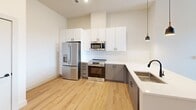 This contemporary 1000 square foot apartment in Metuchen, NJ offers a harmonious blend of style and functionality. The open-concept design creates a seamless flow between living spaces, enhanced by light wood flooring throughout. The kitchen is a standout feature, boasting sleek white and gray cabinetry, stainless steel appliances, and a convenient built-in microwave.

Both bedrooms are generously sized, with the primary bedroom measuring 170 square feet. Large windows in the bedrooms provide ample natural light and scenic views. The two bathrooms are elegantly appointed with modern fixtures, including double vanities in one, and stylish lighting.

Storage is abundant with two closets and additional built-in storage solutions. The apartment includes an in-unit laundry area, adding to its convenience. The neutral color palette and clean lines create a fresh, modern ambiance throughout the space.

Located at 212 Durham Ave in Metuchen, this single-story apartment combines urban sophistication with suburban comfort, making it an ideal residence for those seeking a contemporary living experience.