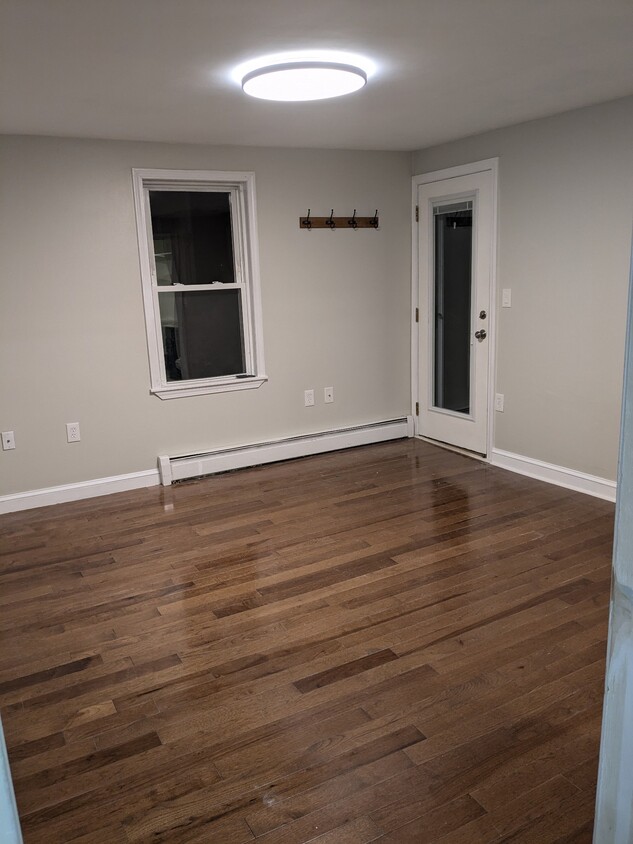 Living room and entrance door to covered porch - 15 Osgood St