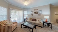 Located at 735 Candler Lane in Charlotte, NC, this single-floor residence offers a thoughtfully designed layout that balances comfort and functionality throughout its living spaces. Neutral-toned walls, plush carpeting in the living and bedroom areas, and wood-look flooring in the kitchen and bathrooms create a cohesive aesthetic throughout.

The living room is bright and welcoming, featuring crown molding, a ceiling light fixture, and large sliding glass doors dressed with vertical blinds that invite natural light and provide outdoor access. This space flows seamlessly into a dedicated dining area, making the open-concept arrangement ideal for entertaining.

The kitchen is well-equipped with white cabinetry, granite-look countertops, stainless steel appliances, and wood-look flooring. A separate pantry provides generous storage. Multiple bedrooms are generously proportioned, each with carpeting, windows with blinds, and ceiling light fixtures. One bedroom includes a walk-in closet, adding practical storage.

The bathrooms are finished with granite-topped white vanities, wood-look tile flooring, and tub-shower combinations. One bathroom connects directly to a bedroom, offering added privacy and convenience. Overall, the residence presents a clean, comfortable atmosphere suited for everyday living.