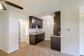 Located on Wildwood Street in Roseville, Michigan, this single-floor, one-bedroom, one-bathroom unit offers a well-organized and functional layout. The combined living and dining area forms the heart of the home, featuring neutral carpet flooring, a ceiling fan with light fixture, and a clean, open feel that allows for versatile furniture arrangements. The space flows naturally into the semi-open kitchen, which is fitted with rich dark espresso-stained shaker cabinets, granite-style countertops, a double-basin stainless steel sink, and stainless steel appliances including a refrigerator, electric range, and microwave. Light wood-tone flooring anchors the kitchen, which is brightened by a stylish flush-mount ceiling light. The spacious primary bedroom includes a large window that brings in natural light and offers outdoor views of the surrounding greenery, complemented by carpet flooring and baseboard heating. Three closets throughout the unit provide generous storage. The full bathroom features a tub-shower combination with tile surround, wood-tone flooring, and clean, minimal finishes. A dedicated entrance and hallway complete the efficient floor plan, making this a well-appointed unit designed for comfortable everyday living.