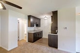 Located on Wildwood Street in Roseville, Michigan, this single-floor, one-bedroom, one-bathroom unit offers a well-organized and functional layout. The combined living and dining area forms the heart of the home, featuring neutral carpet flooring, a ceiling fan with light fixture, and a clean, open feel that allows for versatile furniture arrangements. The space flows naturally into the semi-open kitchen, which is fitted with rich dark espresso-stained shaker cabinets, granite-style countertops, a double-basin stainless steel sink, and stainless steel appliances including a refrigerator, electric range, and microwave. Light wood-tone flooring anchors the kitchen, which is brightened by a stylish flush-mount ceiling light. The spacious primary bedroom includes a large window that brings in natural light and offers outdoor views of the surrounding greenery, complemented by carpet flooring and baseboard heating. Three closets throughout the unit provide generous storage. The full bathroom features a tub-shower combination with tile surround, wood-tone flooring, and clean, minimal finishes. A dedicated entrance and hallway complete the efficient floor plan, making this a well-appointed unit designed for comfortable everyday living.