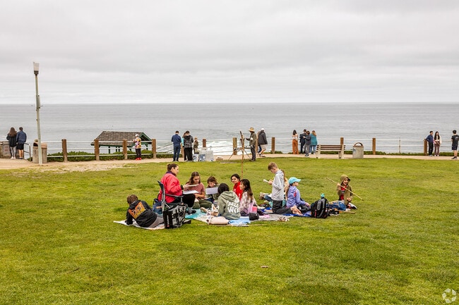 People sit in Ellen Browning Scripps Park.