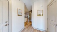 This thoughtfully designed one-bedroom, one-bathroom residence in Buffalo, NY delivers a modern living experience within a well-appointed single-floor layout. The open-concept kitchen and living area serves as the heart of the home, featuring a granite-topped peninsula with bar seating, white shaker cabinetry, a classic subway tile backsplash, and a full suite of stainless steel appliances including a refrigerator, range, and built-in microwave. Pendant lighting above the peninsula adds a refined touch to the space. The living room is bright and inviting, with light hardwood-style flooring, a sliding glass door that draws in natural light, and ample room for comfortable seating arrangements. The generously sized bedroom offers plush carpeting, a ceiling fan, and a window with outdoor views, creating a calm and restful retreat. A walk-in closet provides convenient storage. The bathroom is clean and spacious, featuring wood-look flooring, a tub-shower combination, and tasteful décor accents. A dedicated utility room rounds out the functional layout. Neutral tones and contemporary finishes are carried throughout, creating a cohesive and polished ambiance across the entire residence.