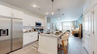 This well-appointed 2-bedroom, 2-bathroom residence at 900 Mountaintop Ave in Gainesville, GA offers a thoughtfully designed open-concept layout. The kitchen is a standout centerpiece, featuring crisp white cabinetry, granite countertops, stainless steel appliances, and a large island with pendant lighting and bar seating that flows seamlessly into the living area. The living room is bright and inviting, with large windows that allow generous natural light and a bold accent wall that adds character to the space. Luxury vinyl plank flooring runs throughout, lending a clean, cohesive aesthetic. The primary bedroom offers a comfortable, light-filled retreat with a large window and a dedicated walk-in closet with multi-tier wire shelving. The second bedroom is equally well-lit, featuring a ceiling fan and its own closet. Both bathrooms are finished with granite-topped vanities, white cabinetry, and tile accents. The primary bath includes a soaking tub and direct access to the walk-in closet. Recessed lighting throughout and a neutral color palette create a polished, modern ambiance across the entire residence.