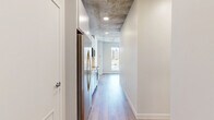Located on the 9th floor at 333 Superior St in downtown Duluth, Minnesota, this one-bedroom, one-bathroom unit offers a well-designed urban living space with a blend of industrial and contemporary finishes throughout. Exposed concrete ceilings lend an authentic loft character to the home, complemented by warm wood-look plank flooring that runs continuously across the open layout.

The kitchen is efficiently designed with white cabinetry, a white subway tile backsplash, quartz countertops, and a full suite of stainless steel appliances including a refrigerator, range, and over-the-range microwave. It opens directly into the living area, which benefits from a large floor-to-ceiling window framing sweeping city views of the Duluth skyline.

The bedroom continues the industrial aesthetic with exposed concrete ceilings, clean white walls, and rich wood-tone flooring, providing a cozy yet modern retreat. A dedicated closet offers practical storage.

The bathroom is finished to a high standard, featuring a white vanity with quartz countertop, a backlit LED mirror, and a tub/shower combo fully tiled in crisp vertical white subway tile with brushed nickel fixtures. Wood-look flooring ties the bathroom seamlessly to the rest of the unit. This thoughtfully designed space delivers modern comfort in the heart of downtown Duluth.