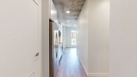 Located on the 9th floor at 333 Superior St in downtown Duluth, Minnesota, this one-bedroom, one-bathroom unit offers a well-designed urban living space with a blend of industrial and contemporary finishes throughout. Exposed concrete ceilings lend an authentic loft character to the home, complemented by warm wood-look plank flooring that runs continuously across the open layout.

The kitchen is efficiently designed with white cabinetry, a white subway tile backsplash, quartz countertops, and a full suite of stainless steel appliances including a refrigerator, range, and over-the-range microwave. It opens directly into the living area, which benefits from a large floor-to-ceiling window framing sweeping city views of the Duluth skyline.

The bedroom continues the industrial aesthetic with exposed concrete ceilings, clean white walls, and rich wood-tone flooring, providing a cozy yet modern retreat. A dedicated closet offers practical storage.

The bathroom is finished to a high standard, featuring a white vanity with quartz countertop, a backlit LED mirror, and a tub/shower combo fully tiled in crisp vertical white subway tile with brushed nickel fixtures. Wood-look flooring ties the bathroom seamlessly to the rest of the unit. This thoughtfully designed space delivers modern comfort in the heart of downtown Duluth.