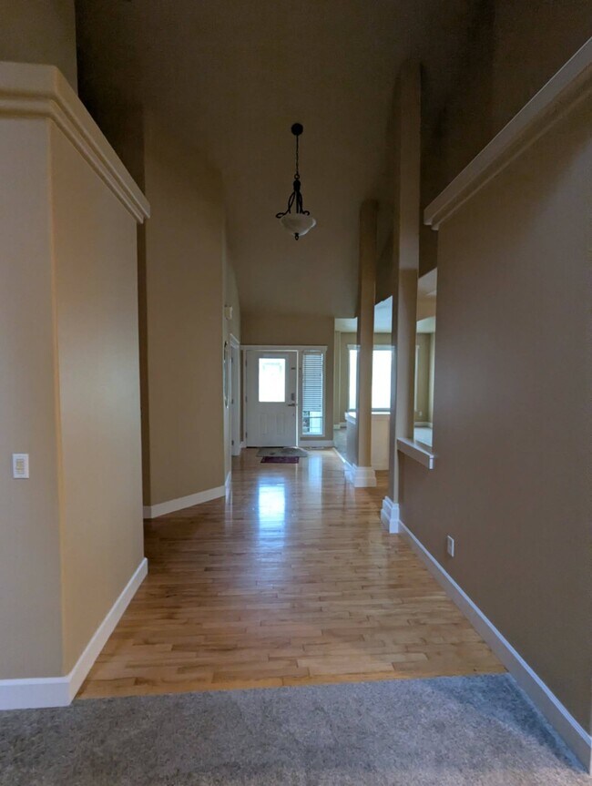 Towards the front door from the family room and kitchen with kitchenette - 9535 Piperhill Dr SE