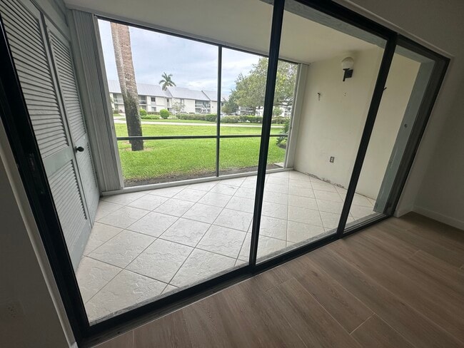Large screened lanai with lots of outdoor closet storage - 2223 NW 22nd Ave