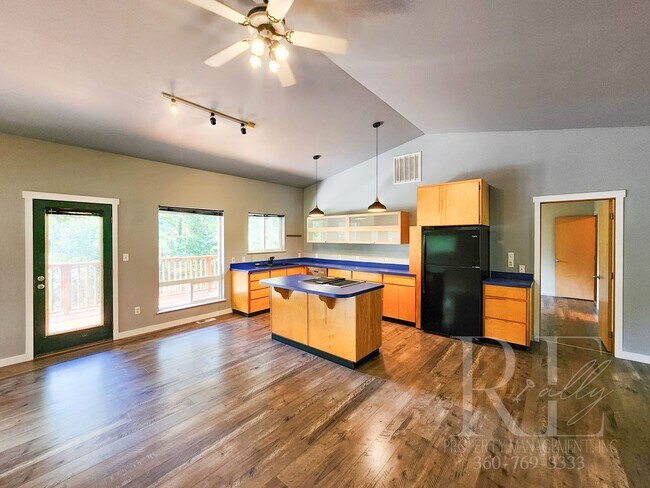 Building Photo - Vaulted Ceilings, Unique Designer Kitchen & Expansive Half-Acre Setting with Flexible Living Spaces