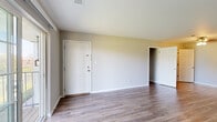 This single-floor residence at Woodbridge Place in Evansville, Indiana offers a well-designed layout with a blend of practical finishes and comfortable living spaces throughout. The main living area features durable wood-look flooring and neutral-toned walls, creating a bright and open atmosphere. A sliding glass door floods the space with natural light and provides direct access to the outdoors. A ceiling fan adds comfort to the open living space, which connects seamlessly to adjacent rooms. The kitchen is outfitted with warm wood cabinetry, granite-style countertops, and black appliances, including a refrigerator, dishwasher, and range. A dedicated in-unit laundry closet is conveniently accessible directly from the kitchen and includes a full-size washer and dryer. The bedrooms are carpeted for comfort and feature large windows that invite ample natural light. The primary bedroom includes access to a walk-in closet, providing generous storage space. The bathroom is well-appointed with rich wood vanity cabinetry, a white countertop, a lighted mirror, and a tub-shower combination with wood-look flooring that ties the space together. Clean lines, neutral tones, and functional finishes make this a move-in-ready residence.