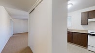 Located at 7511 E Culver St in Scottsdale, Arizona, this two-bedroom, one-bathroom single-story residence offers a practical and well-organized layout. The kitchen features dark wood cabinetry providing ample upper and lower storage, a double-basin stainless steel sink, laminate countertops, and tile-style flooring, all brightened by a natural light source through a window with blinds. Hallways connect the main areas efficiently, contributing to a cohesive flow throughout the home. The primary bedroom is generously sized and features carpet flooring, painted brick walls, a textured ceiling, and a sliding glass door that opens to a private balcony with a decorative railing — a standout feature that brings in natural light and outdoor access. The second bedroom also offers carpet flooring, painted brick walls, a textured ceiling, and a window overlooking the exterior, providing a comfortable and well-lit space. Bedroom storage is addressed with sliding-door closets. The bathroom includes an extended vanity countertop with a single sink, a mirrored medicine cabinet, and a separate room housing the toilet and a full bathtub with a shower. Throughout the residence, the neutral color palette and consistent finishes create a clean, understated ambiance suited for everyday living.