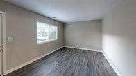 Located at 1357 Skyhawk Cir in Virginia Beach, VA, this two-story home offers three bedrooms, two bathrooms, and a practical layout spread across two floors. The main level features wood-look plank flooring throughout the living room and dining area, complemented by neutral-toned walls that create a clean, versatile aesthetic. The kitchen is a standout feature, outfitted with dark espresso-toned shaker cabinets, light speckled countertops, black appliances including a refrigerator, range, and dishwasher, as well as a stainless steel sink — all set over the same durable wood-look flooring. Both bathrooms are finished with white countertop vanities, framed mirrors, and brushed nickel fixtures, with one bathroom including a tub-shower combination. The upper level houses the bedrooms, each carpeted in a neutral tone and painted in soft gray and beige hues. The spacious primary bedroom includes two closets, while the additional bedrooms offer ample room and their own closet storage. A dedicated laundry area and multiple hallway closets add to the home's functional storage capacity. Consistent neutral paint tones and clean white trim throughout give the home a cohesive, move-in ready feel.