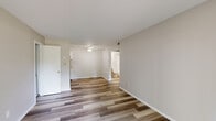 Located at 315 Woodlawn Ave in O'Fallon, Missouri, this single-floor, one-bedroom, one-bathroom unit offers a practical and well-organized layout. The combined kitchen and living room area features durable wood-look plank flooring and a ceiling fan, creating a bright and functional common space. A sliding glass door in the living area fills the room with natural light and provides direct views of the surrounding greenery outdoors. The galley-style kitchen is efficiently designed with white cabinetry, light countertops, a stainless steel refrigerator, a dishwasher, and a single-basin sink — all set over matching wood-look flooring. The bedroom is carpeted for comfort and includes a dedicated closet, a large window that invites natural light and outdoor views, and access to both the hallway and closet via separate doors. The full bathroom features a clean, white tub-shower combination. A hallway connects the main living areas to the bedroom and bathroom, completing the unit's logical flow. Textured ceilings throughout add a subtle architectural detail, and neutral wall tones provide a versatile backdrop throughout the space.