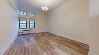 Located on Boylston Street in the heart of Boston, MA, this single-floor unit offers a thoughtfully designed living space with a blend of classic and contemporary finishes. The main living area features warm hardwood-style flooring, crisp white crown molding, and an elegant chandelier that adds a touch of sophistication. A set of windows, accented by decorative stained glass transoms, allows natural light to fill the room, creating a bright and welcoming atmosphere. A wall-mounted rail system provides practical storage potential throughout the space. The kitchen is efficiently outfitted with rich dark wood cabinetry, granite countertops, a subway tile backsplash, and stainless steel appliances including an electric range with overhead ventilation and a full-size refrigerator. The bathroom showcases a classic black-and-white mosaic tile floor, white subway wall tiles with dark accent trim, a combined tub and shower enclosed by sliding glass doors, and a dark wood vanity topped with granite. Together, these elements create a cohesive and functional living environment well-suited to urban Boston living.