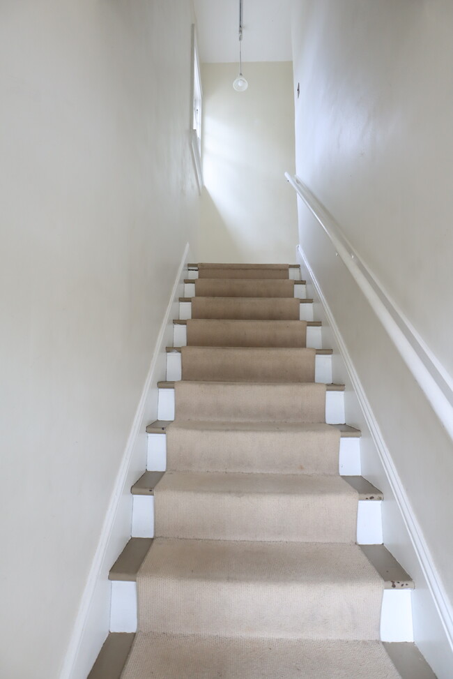 Stairs to living space - 114 E Maple St