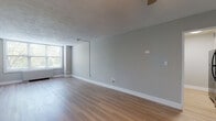 Located at 425 Dayton Towers Dr in Dayton, Ohio, this single-floor unit offers a clean, modern aesthetic with a cohesive design throughout. Light wood-style flooring runs continuously across the living spaces, complementing the soft gray walls and crisp white baseboards for a fresh, contemporary feel.

The spacious living area is generously sized, allowing ample room for a variety of furniture arrangements. Large windows with horizontal blinds invite abundant natural light while offering views of surrounding greenery. A ceiling fan with an integrated light fixture provides both comfort and illumination. The textured ceiling adds a subtle architectural detail to the open space.

The galley-style kitchen is efficiently designed with white shaker cabinetry, gray countertops, a double-basin stainless steel sink, and black appliances including a gas range, microwave, and refrigerator — providing all the essentials in a compact, functional layout.

The bathroom is neatly finished with white subway-style wall tile surrounding a full tub and shower, a white vanity with storage, and a well-lit mirror above. Light wood flooring carries through from the main living areas, maintaining visual continuity.

Overall, the unit presents a move-in ready environment with updated finishes, practical layouts, and a bright, welcoming ambiance throughout.