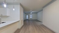 This single-story apartment offers a harmonious blend of style and functionality. The open concept living area boasts wood-look flooring, recessed lighting, and a ceiling fan. The kitchen impresses with white cabinetry, stainless steel appliances, and a subway tile backsplash. Two bathrooms feature modern fixtures, including a shower/tub combo and vanity lighting. Bedrooms are bright with large windows and ample closet space. The neutral color palette and clean lines create a contemporary ambiance, while the spacious layout ensures comfort and versatility for various lifestyle needs.