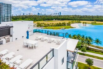 Elevated rooftop sundeck with sweeping lagoon and skyline views. tour today and find your perfect home! - SoLe Mia Rentals
