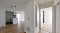 Located at 1200 N June St in the heart of Hollywood, Los Angeles, this 2-bedroom, 2-bathroom residence offers a well-designed single-level layout. The open-concept living and dining area is finished with light hardwood-style flooring and features a classic fireplace as a focal point. Floor-to-ceiling vertical blinds line the large sliding glass door, allowing abundant natural light and outdoor views to fill the space. The galley-style kitchen is efficiently laid out with white cabinetry, a gas range, stainless steel refrigerator, and a double sink — all separated from the main living area by a convenient breakfast bar. Both bedrooms are carpeted for comfort; the spacious primary bedroom includes mirrored sliding closet doors that enhance the sense of space, along with direct access to a walk-in closet. The second bedroom is generously sized with clean white walls and soft carpeting. Each bathroom is finished with wood-look flooring, white cabinetry with light countertops, and a tub-shower combination. The second bathroom features a bright window that brings in natural light. Clean, neutral finishes throughout lend the unit a versatile and move-in ready appeal.