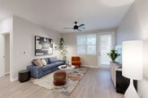 Located in Goodyear, AZ, this well-appointed single-story residence offers 2 bedrooms and 2 bathrooms with a thoughtfully designed open floor plan. Light wood-style flooring flows throughout, complementing the clean, neutral palette that defines the home's modern aesthetic.

The living room is bright and welcoming, featuring a ceiling fan, large windows that invite natural light, and a private exterior door. The kitchen is a standout, boasting warm wood cabinetry, stainless steel appliances, a subway tile backsplash, pendant lighting, and a spacious peninsula with bar seating — ideal for both cooking and entertaining.

A central hallway connects the main living areas to the bedrooms, each equipped with ceiling fans and dedicated closets. The primary bedroom is generously sized with its own closet, while both closets feature built-in shelving and hanging rods for efficient storage.

Both bathrooms reflect the home's contemporary style, showcasing wood-toned vanities with white quartz countertops, matte black fixtures, large mirrors, and wood-look tile flooring. The primary bath includes a walk-in glass shower. Recessed lighting and a cohesive design language carry throughout the entire residence, creating a polished, move-in-ready living environment.